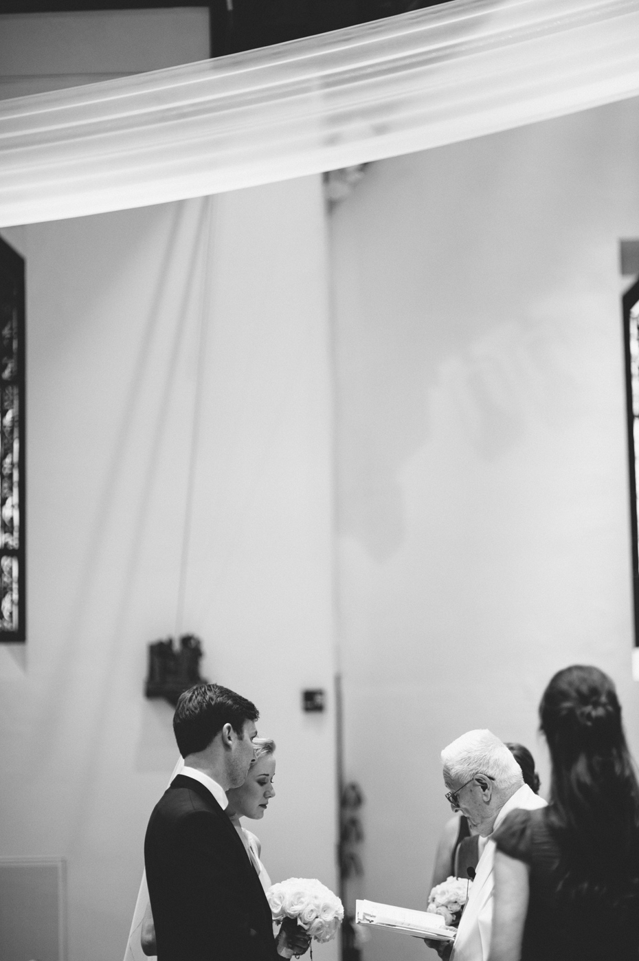 A bride and groom during their wedding at Saint Mary's Student Parish in Ann Arbor, shot by wedding photographer Heather Jowett