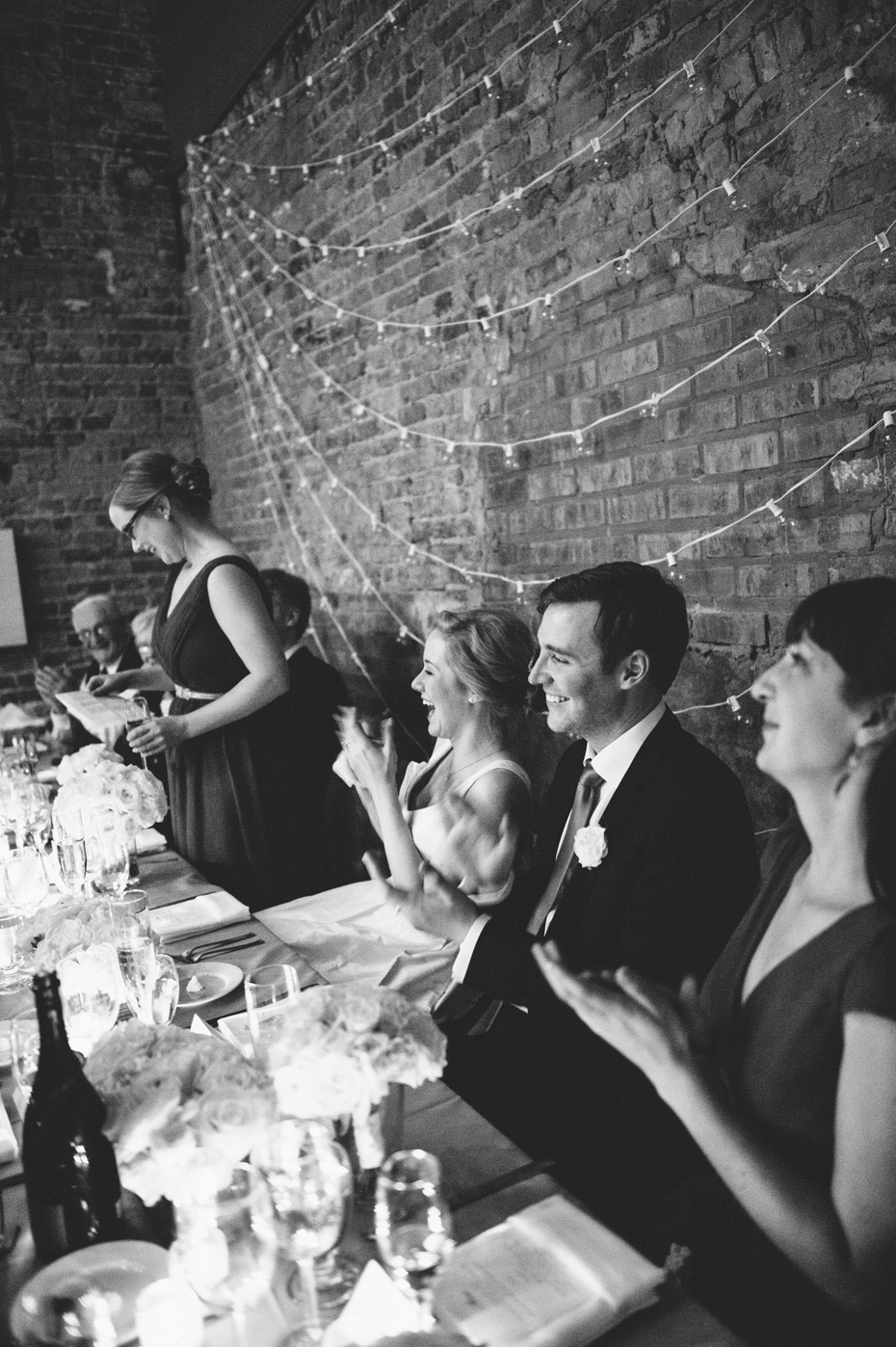 The sisters of the bride and groom share a toast during a wedding reception at Zingerman's Events on Fourth, in Ann Arbor, by Wedding Photographer Heather Jowett