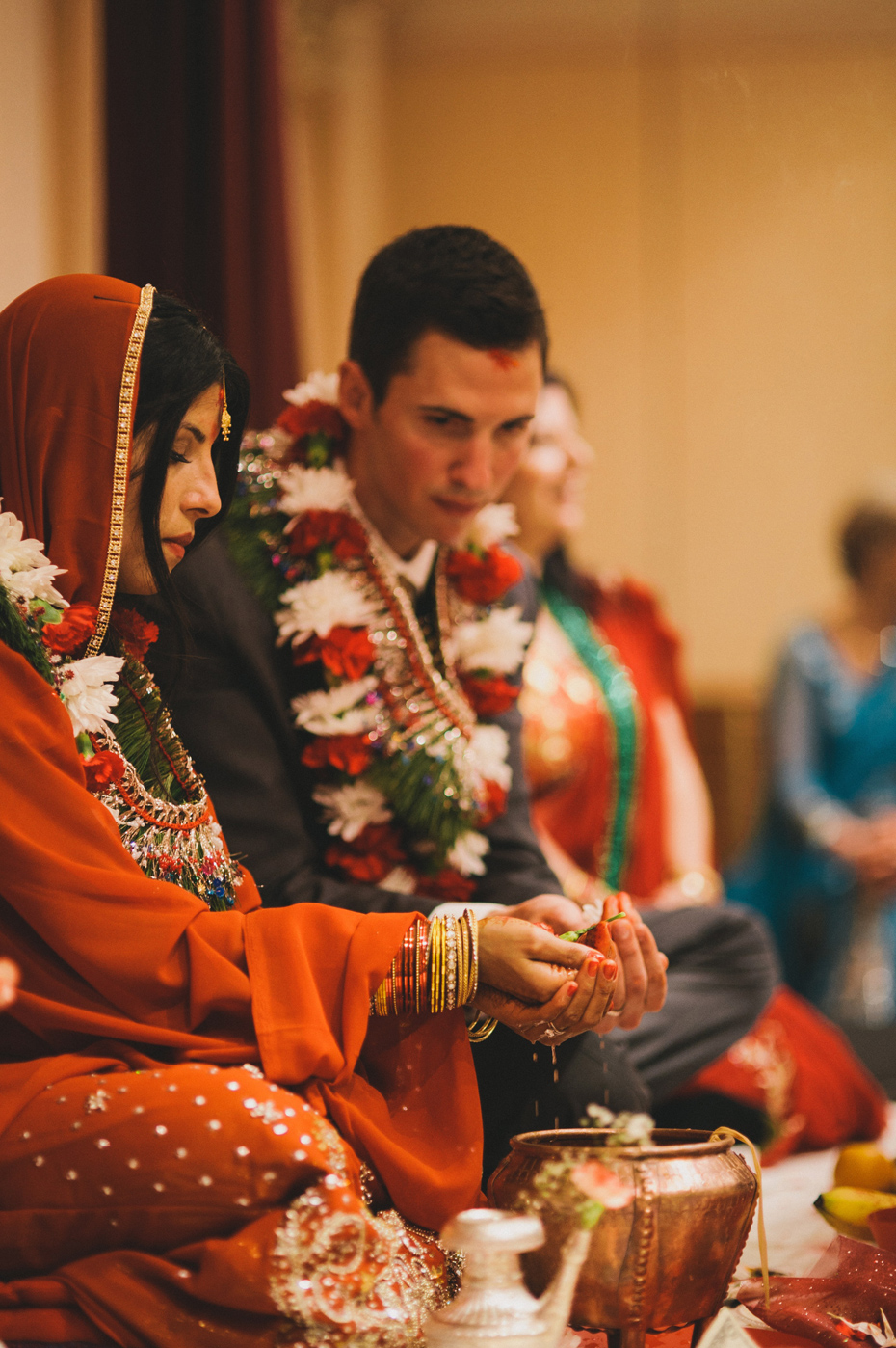 The bride and groom participate in a traditional Nepali Hindu wedding ceremony.