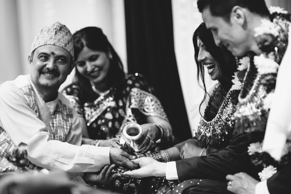 The parents of the bride bless the couple during a hindu wedding ceremony.