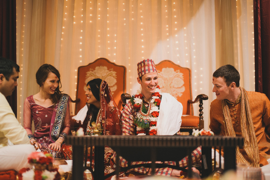The bride and groom invite their friends to participate in a traditional Nepali Hindu wedding ceremony.