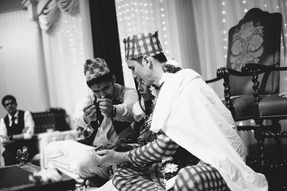 The bride and groom are blessed by the bride's brother in a traditional Nepali Hindu wedding ceremony, by Ann Arbor wedding photographer Heather Jowett.