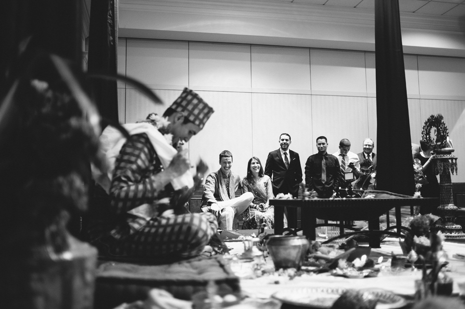 The groom's family watches the wedding ceremony.