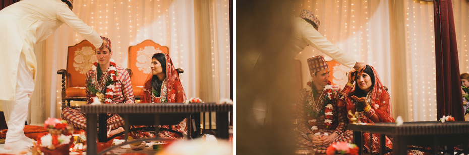 The bride and groom are blessed by a Hindu preist, by Ann Arbor wedding photographer Heather Jowett.