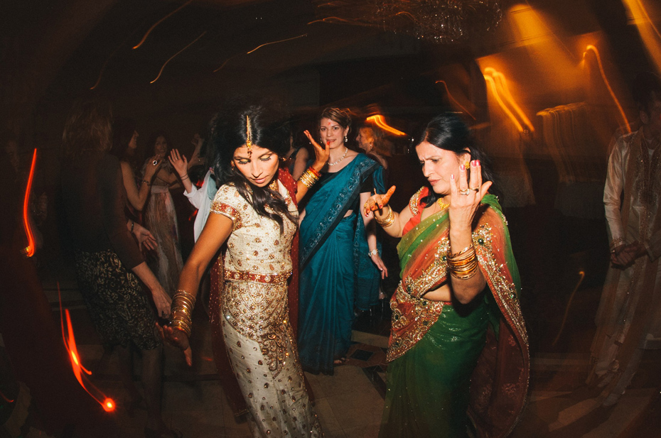 A bride and her mother dance at a hindu wedding reception, by Ann Arbor wedding photographer Heather Jowett.