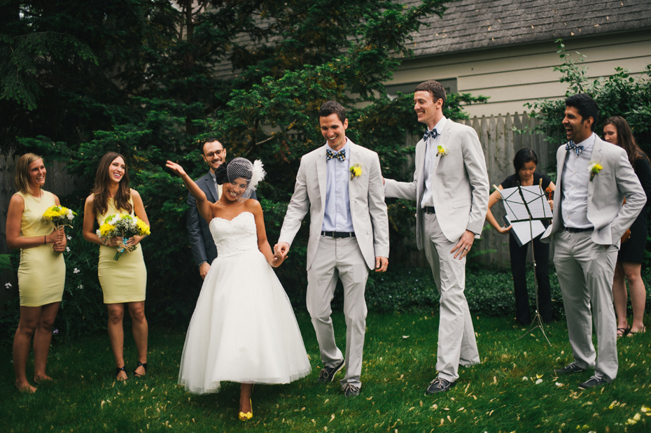 The bride and groom are married in a backyard wedding ceremony, by Ann Arbor wedding photographer Heather Jowett.