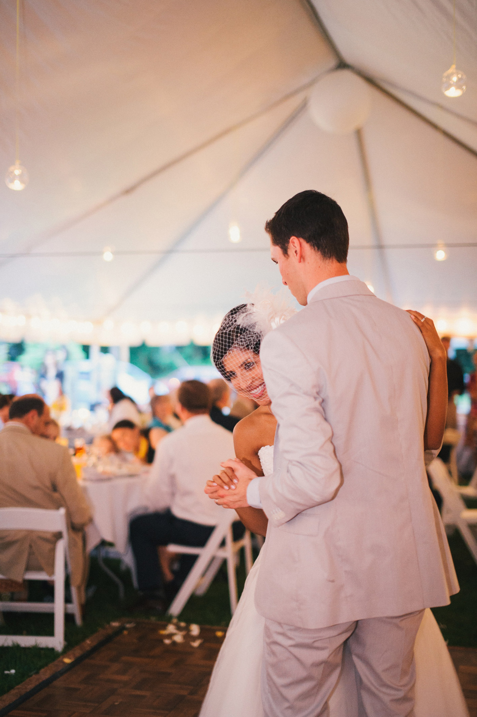 The bride and groom share their first dance at a backyard wedding reception in Kalamazoo Michigan, by Ann Arbor Wedding Photographer Heather Jowett.
