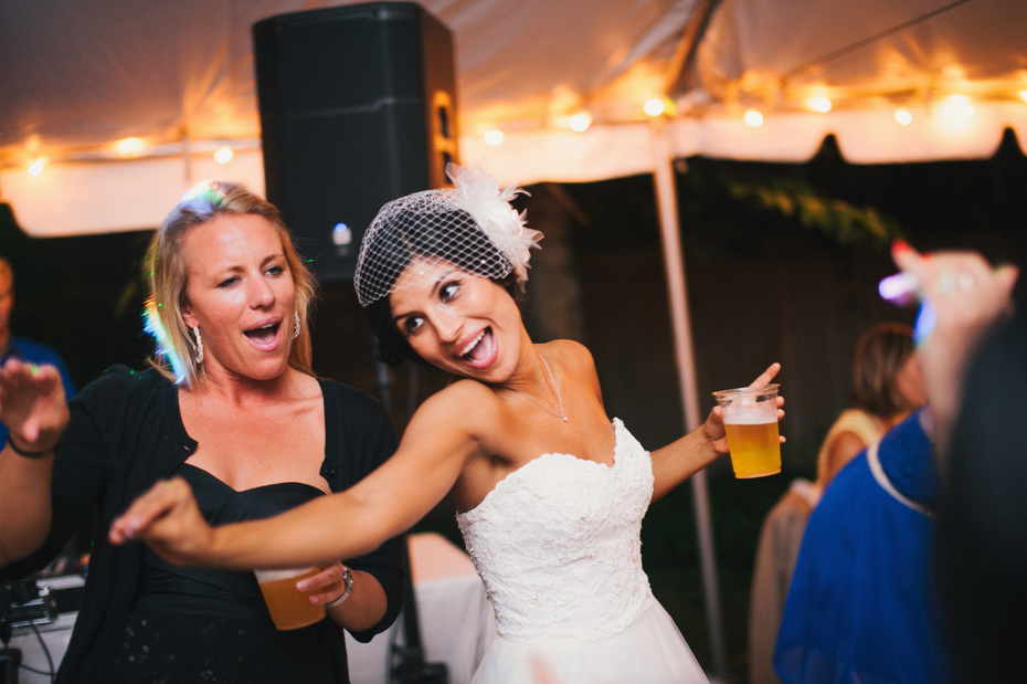 The bride dances at a at a backyard wedding reception.