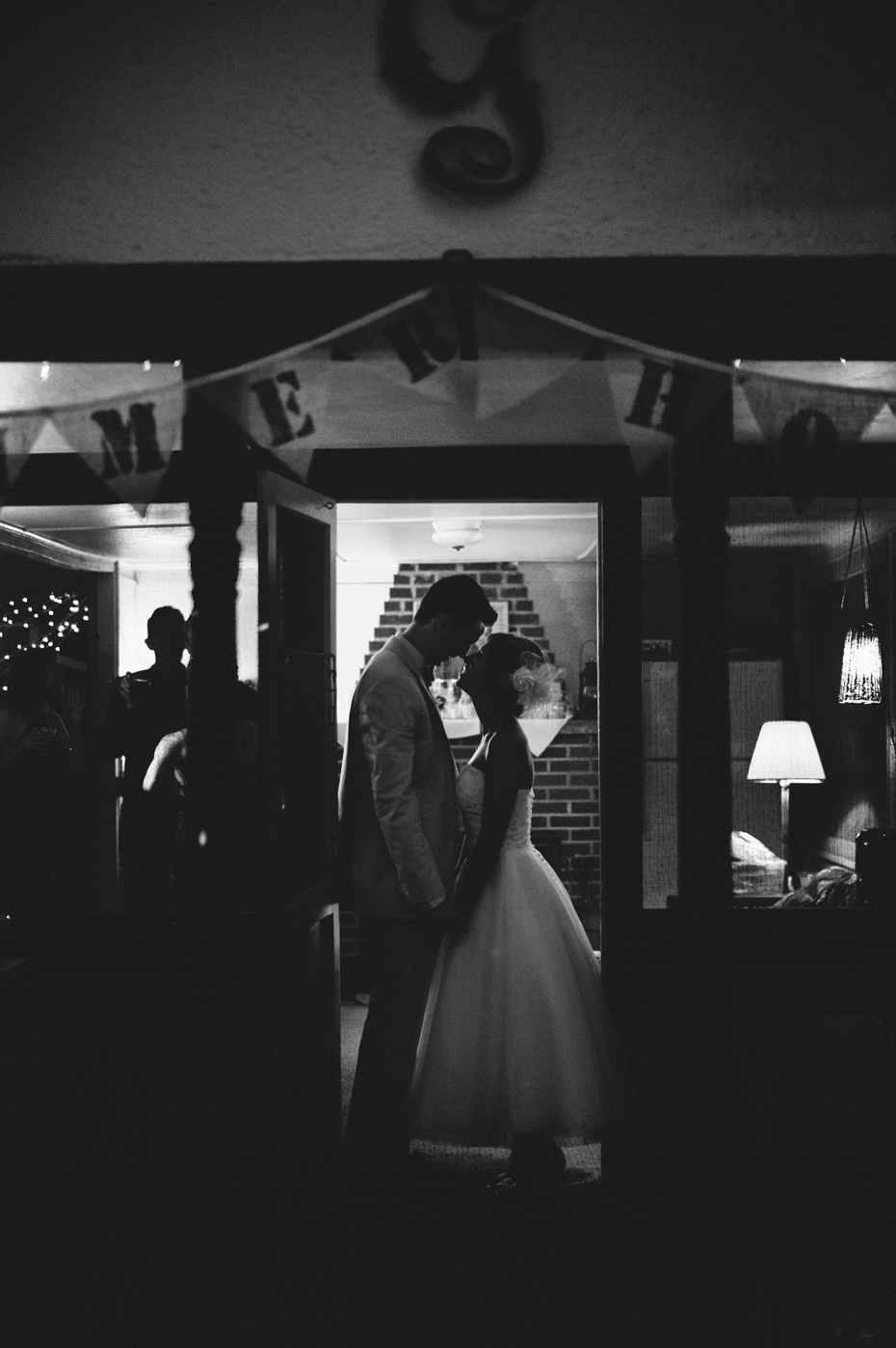The bride and groom share a goodnight kiss at the backyard wedding reception in Michigan, photography by Ann Arbor Wedding Photographer Heather Jowett