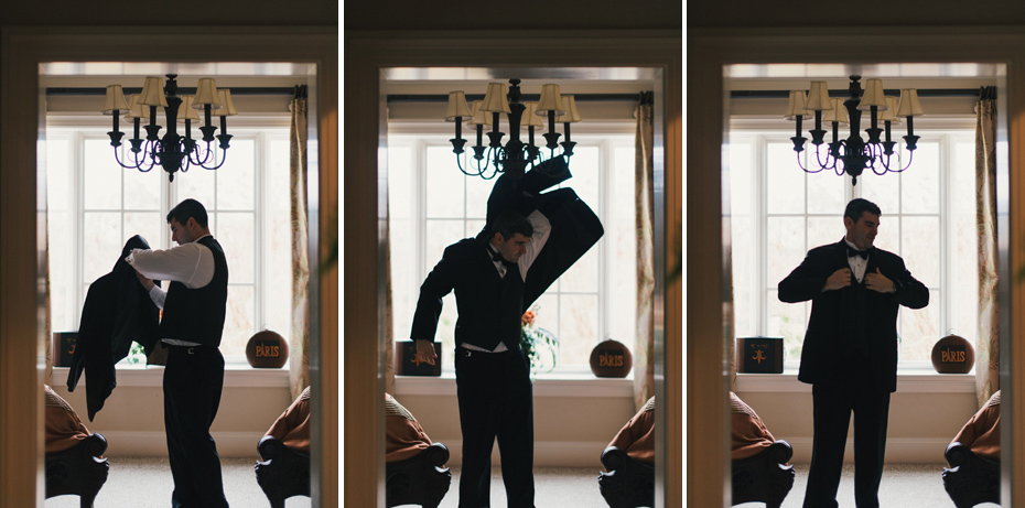 A black and white photo of a bride being helped into her dress at the Fountainview mansion, photographed by Detroit Wedding Photographer Heather Jowett.