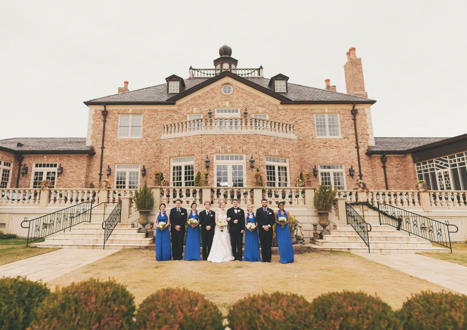 A bride and groom pose with their wedding party at the Fountainview mansion, photographed by Michigan Wedding Photographer Heather Jowett.