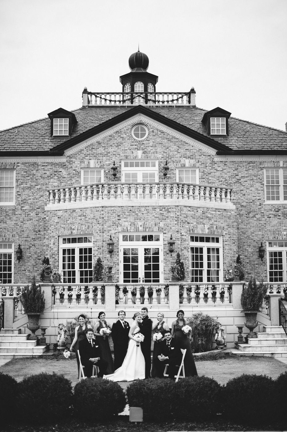 A bride and groom pose with their wedding party at the Fountainview mansion, photographed by Michigan Wedding Photographer Heather Jowett.