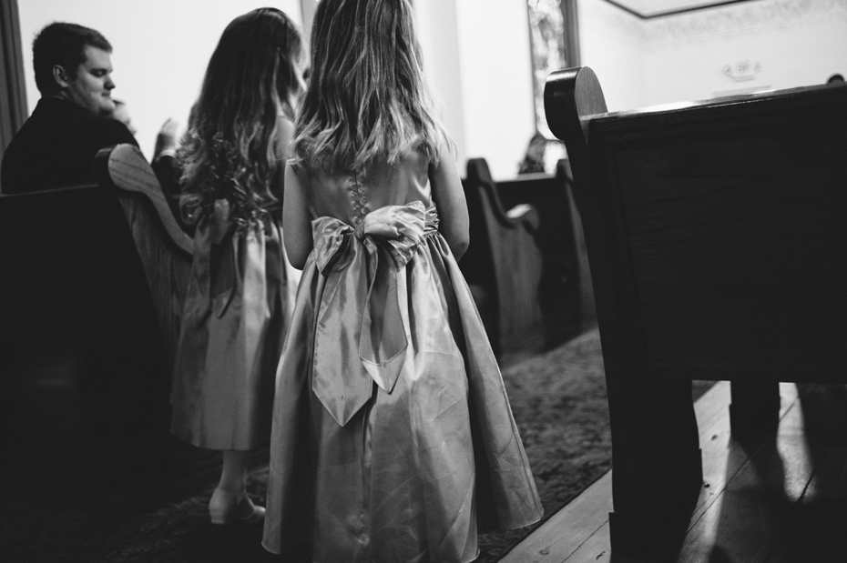 Flower girls start down the aisle, photographed by Ann Arbor Wedding Photographer Heather Jowett.