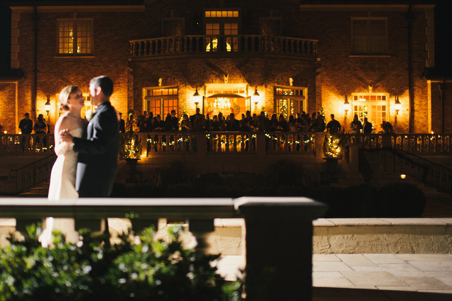 Guests watch as the bride and groom share a first dance at their wedding reception at The Fountainview Mansion in Auburn Alabama, photographed by Ann Arbor Wedding Photographer Heather Jowett.