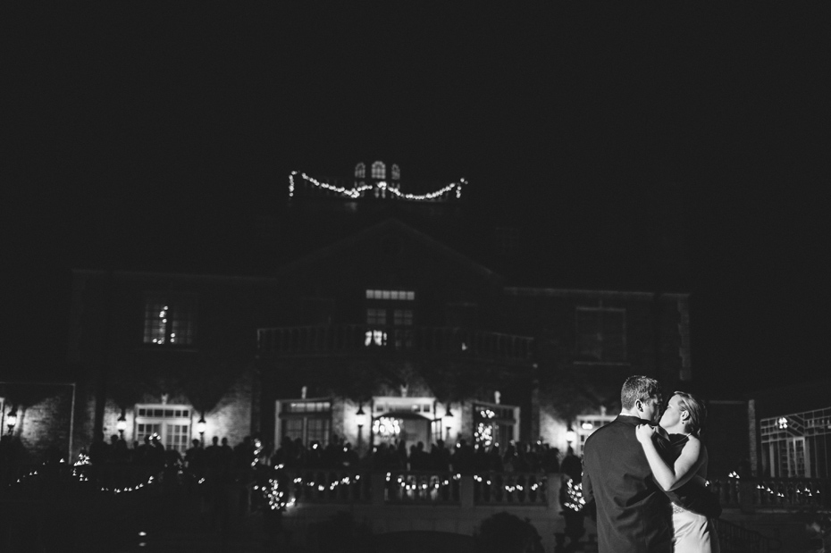 A black and white photo of a bride and groom share a first dance at their wedding reception at The Fountainview Mansion in Auburn Alabama, photographed by Ann Arbor Wedding Photographer Heather Jowett.