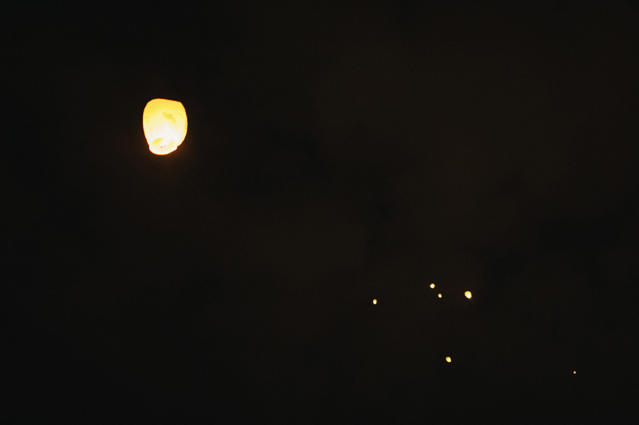 Wedding guests make wishes on chinese lanterns at a wedding reception at The Fountainview Mansion in Auburn Alabama, photographed by Ann Arbor Wedding Photographer Heather Jowett.