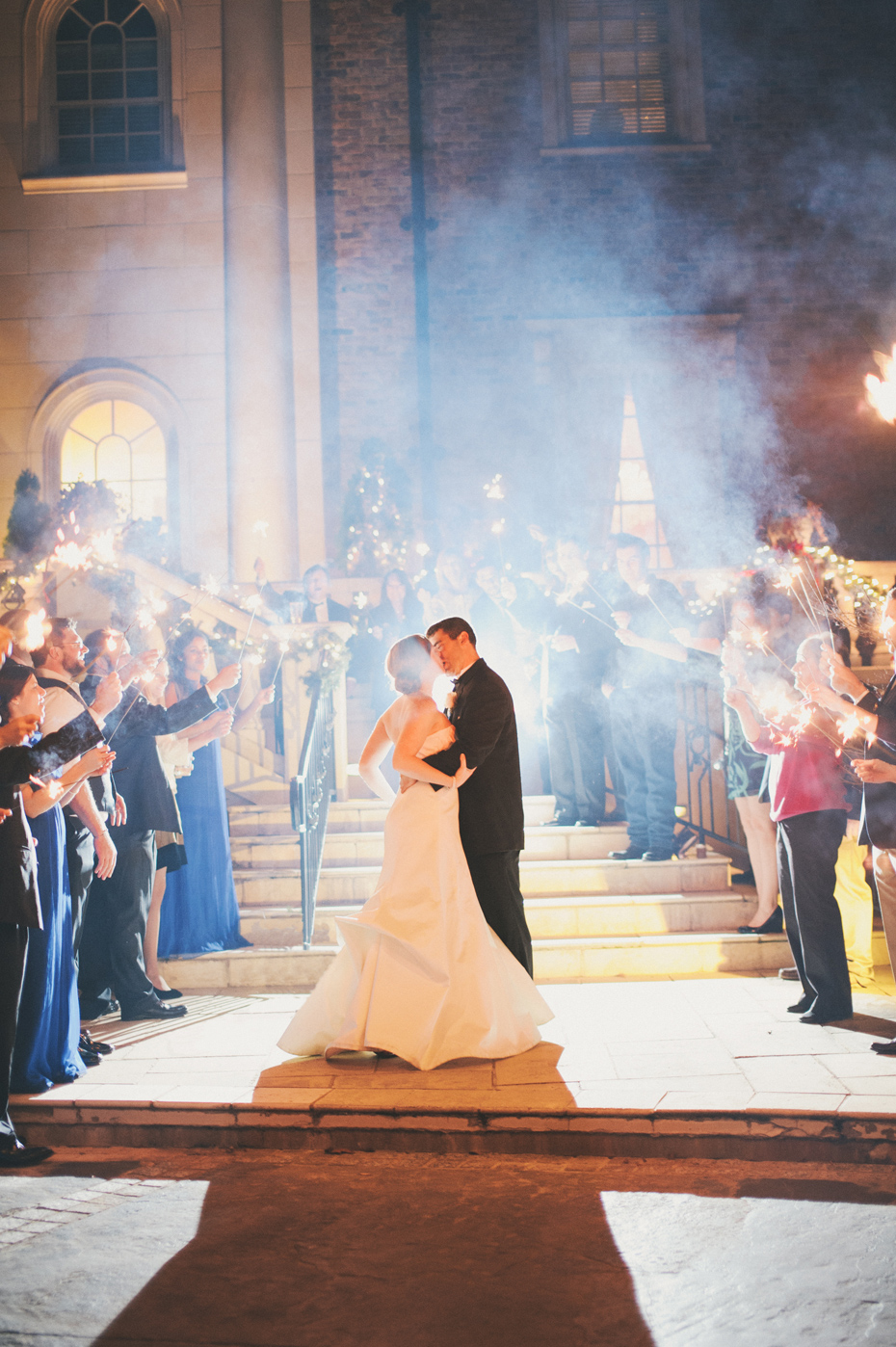 The bride and groom pause for a kiss during their sparkler exit at a wedding reception at The Fountainview Mansion in Auburn Alabama, photographed by Ann Arbor Wedding Photographer Heather Jowett.