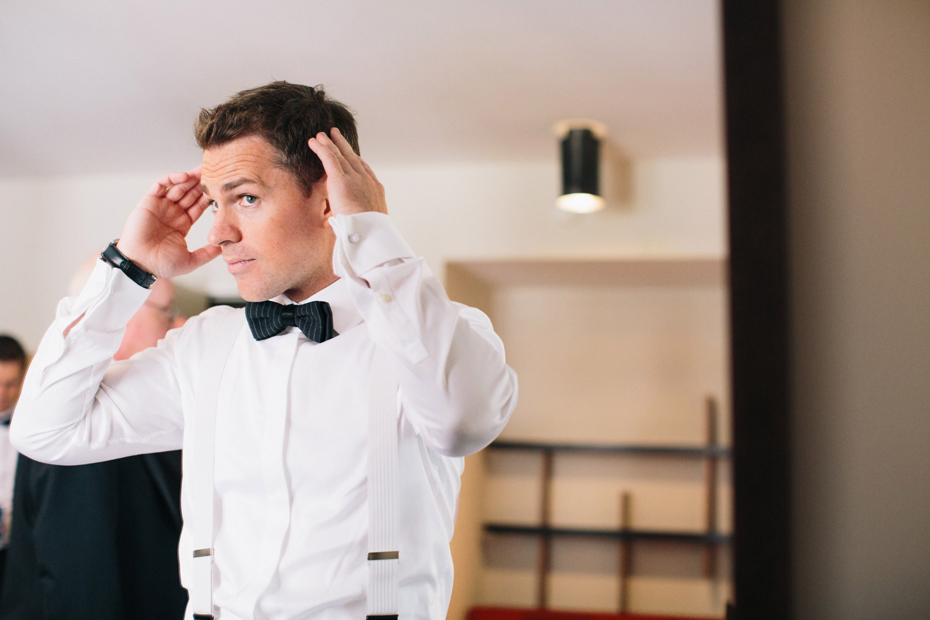 A groom gets dressed at The James Hotel in Chicago, photographed by Ann Arbor Wedding Photographer, Heather Jowett.