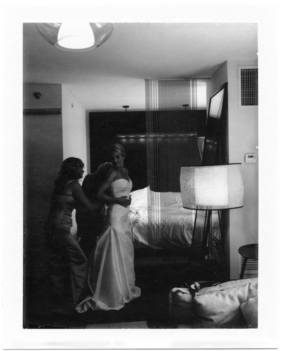 Polaroid photo of a bride getting dressed in Chicago, photographed by Ann Arbor Wedding Photographer, Heather Jowett.