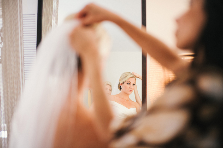 A bride puts on her veil in Chicago, photographed by Ann Arbor Wedding Photographer, Heather Jowett.