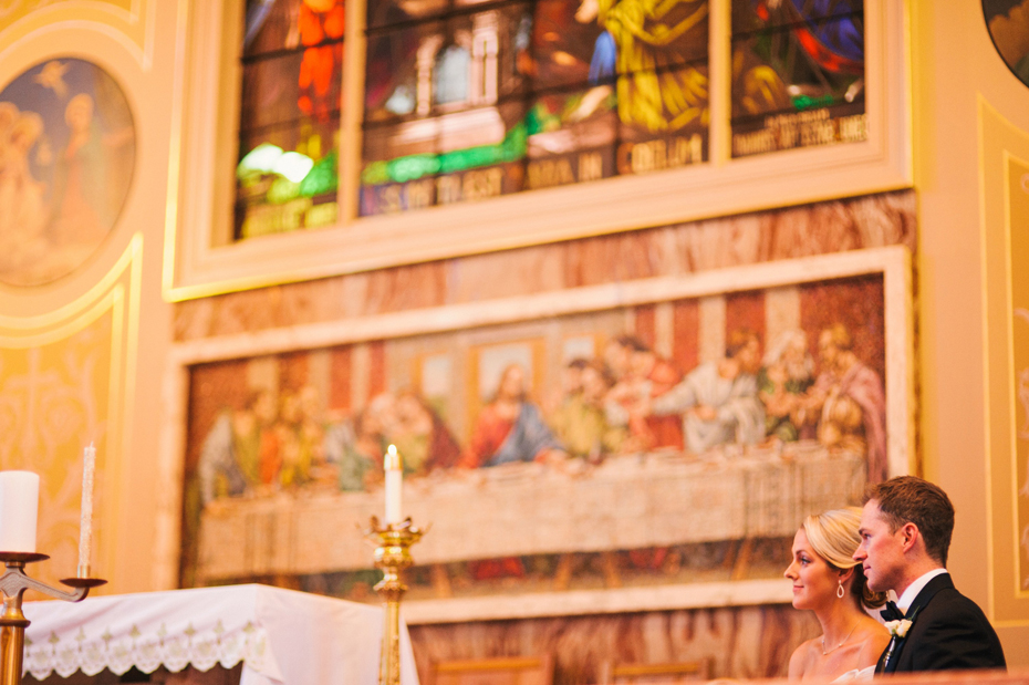 The bride and groom during a catholic wedding mass, photographed by Ann Arbor Wedding Photographer, Heather Jowett.