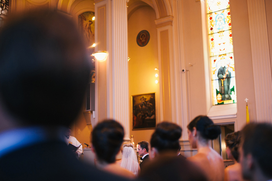 The bride and groom participate in a catholic wedding mass, photographed by Ann Arbor Wedding Photographer, Heather Jowett.