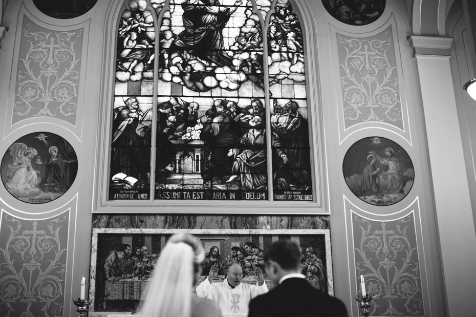 The priest blesses the couple during a catholic wedding mass, photographed by Ann Arbor Wedding Photographer, Heather Jowett
