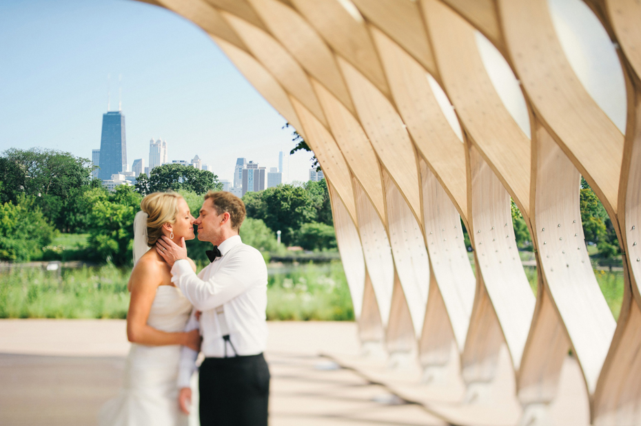 Bride and groom portraits at the Lincoln Park Zoo with a view of the Chicago Skyline, by Michigan Wedding Photographer, Heather Jowett