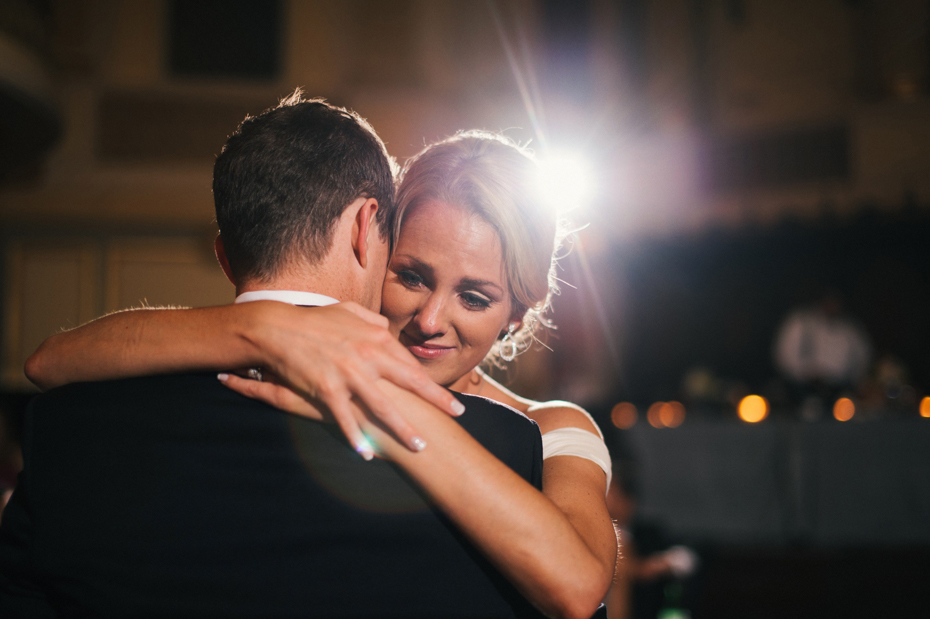 The bride holds back tears during the dance at a wedding reception at The Murphy Building in Chicago, by Michigan Wedding Photographer, Heather Jowett