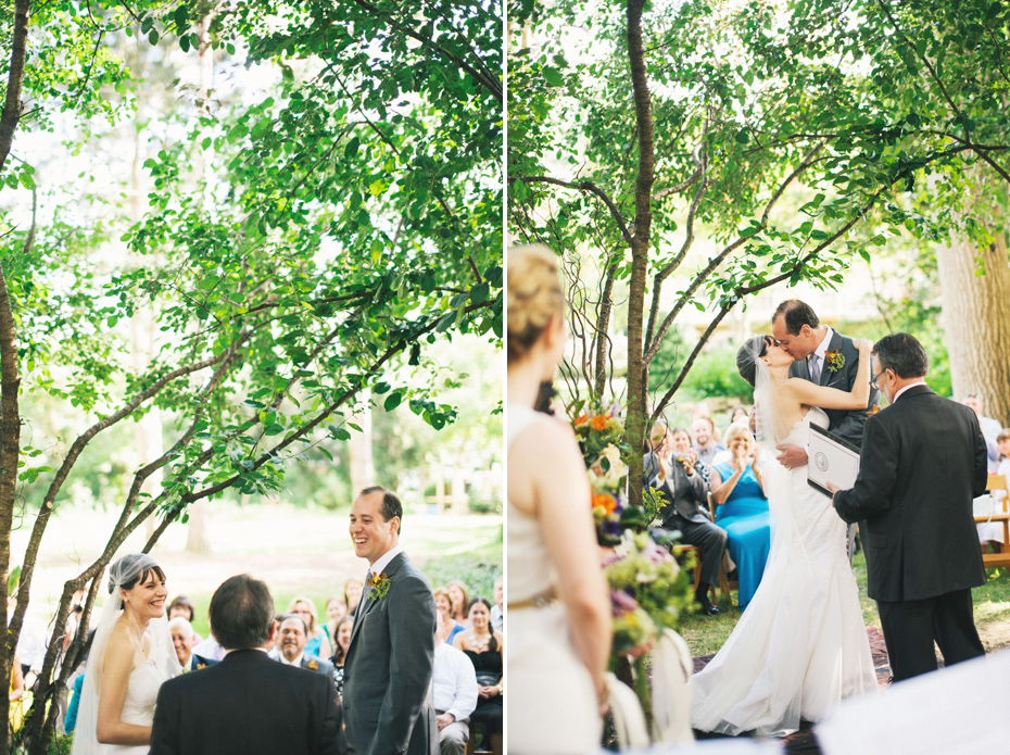 Bride and groom share their first kiss during the ceremony at their backyard wedding in Bloomfield Hills, photographed by Michigan wedding photographer, Heather Jowett.