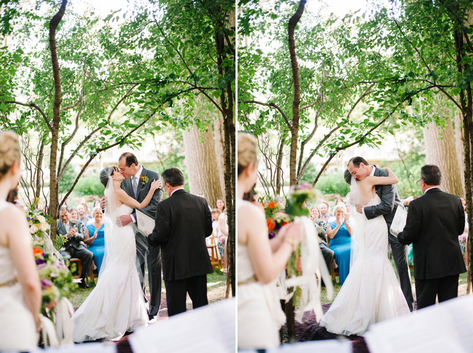 Bride and groom share their first kiss during A backyard wedding by Detroit Michigan wedding photographer, Heather Jowett.