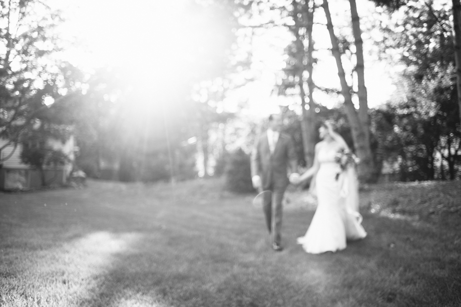 Bride and groom share a quiet moment together after their backyard wedding ceremony by Detroit Michigan wedding photographer, Heather Jowett.