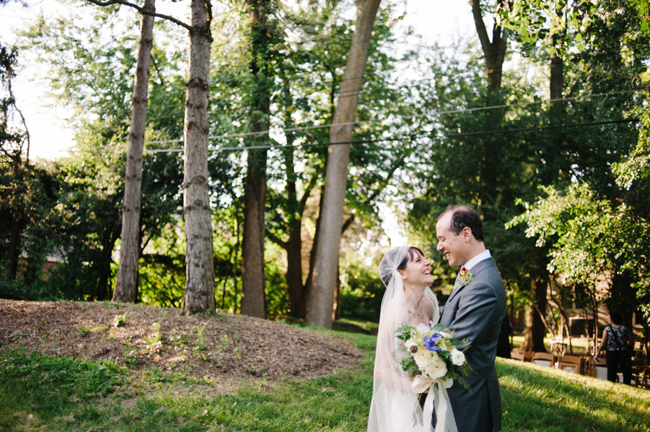 Bride and groom share a quiet moment together after their backyard wedding ceremony by Detroit Michigan wedding photographer, Heather Jowett.