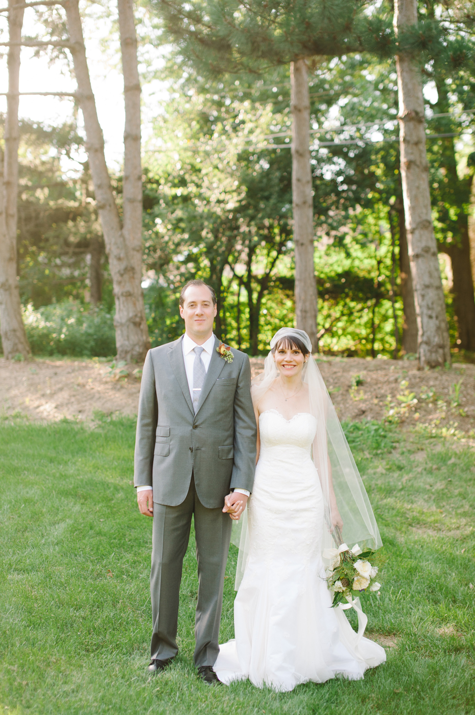 Bride and groom share a quiet moment together after their backyard wedding ceremony by Detroit Michigan wedding photographer, Heather Jowett.