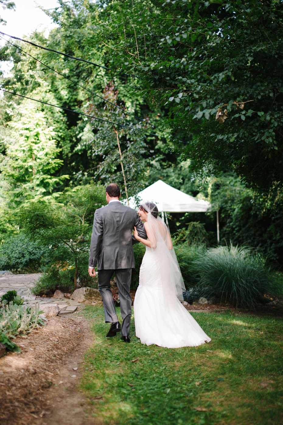 Bride and groom head to their backyard wedding reception by Ann Arbor Michigan wedding photographer, Heather Jowett.