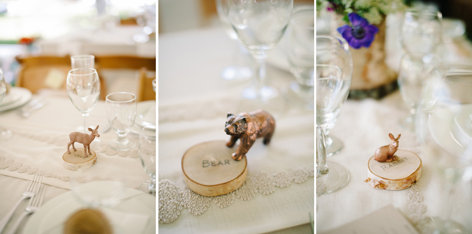 Woodland creatures painted gold serve as DIY table numbers at a backyard wedding reception by Ann Arbor Michigan wedding photographer, Heather Jowett.