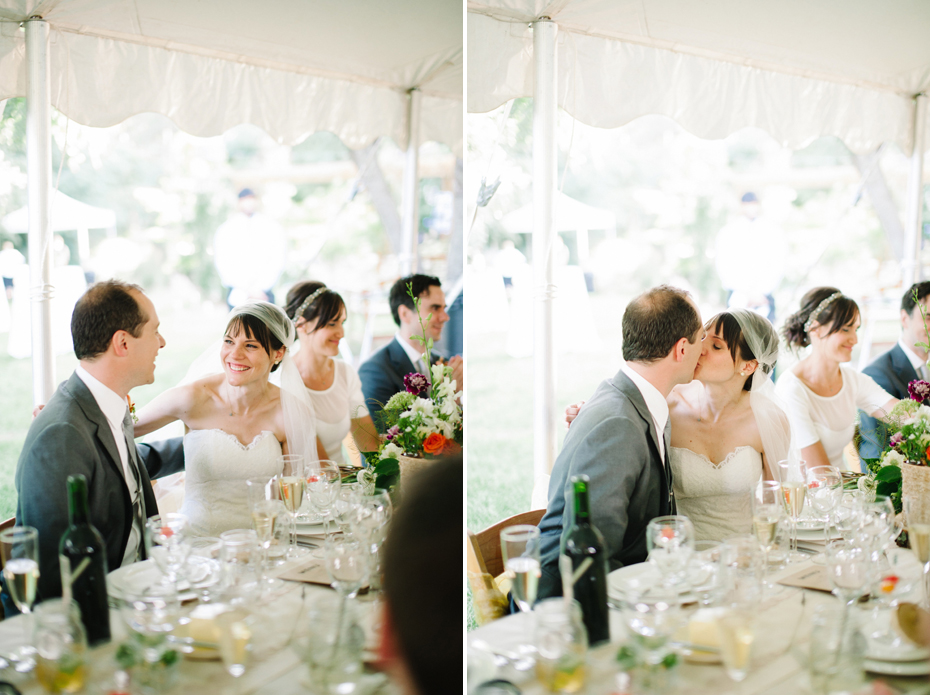 Bride and groom react to the father of the bride's toast at a backyard wedding reception by Ann Arbor Michigan wedding photographer, Heather Jowett.