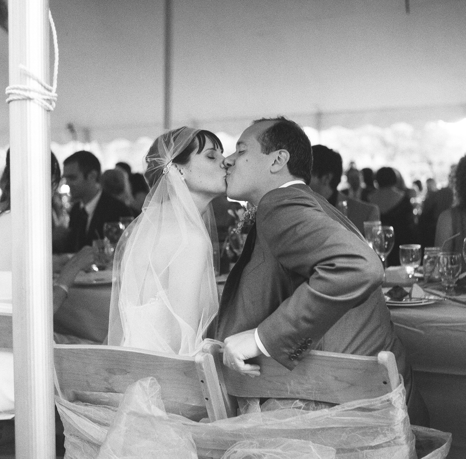 Black and white photo of the bride and groom at their backyard wedding reception by Ann Arbor Michigan wedding photographer, Heather Jowett.