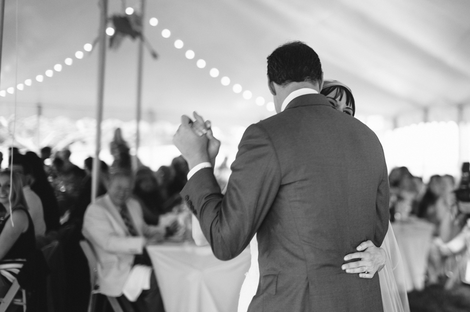 bride and groom share their first dance at their backyard wedding reception by Ann Arbor Michigan wedding photographer, Heather Jowett.