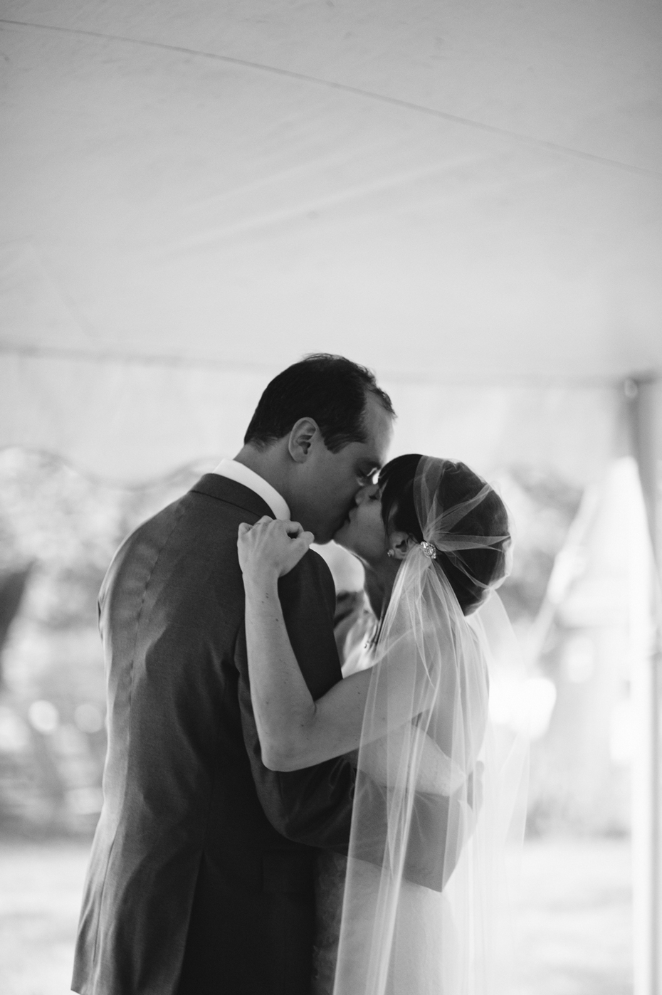 bride and groom share their first dance at their backyard wedding reception by Ann Arbor Michigan wedding photographer, Heather Jowett.