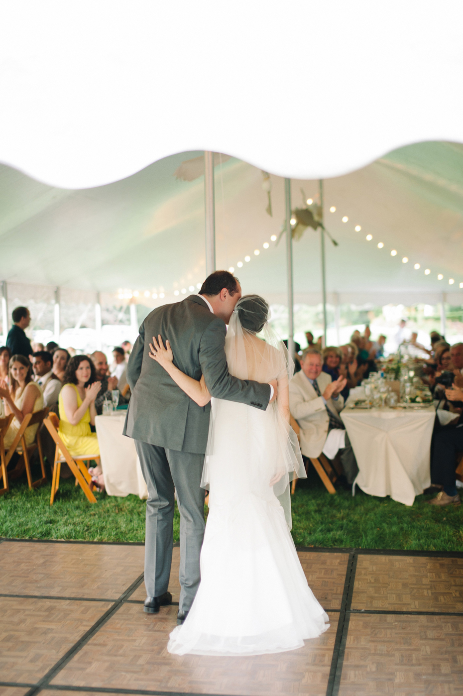 bride and groom share their first dance at their backyard wedding reception by Ann Arbor Michigan wedding photographer, Heather Jowett.