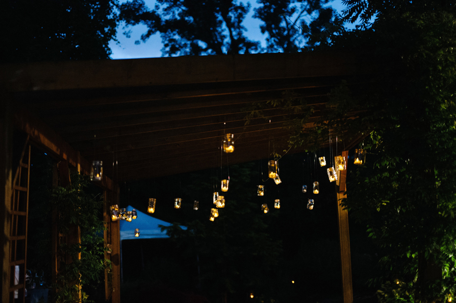 Lit mason jar votives at a Michigan wedding.