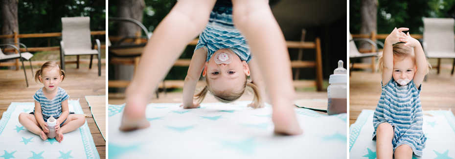 A 2 year old shows off her yoga skills during a lifestyle family portrait session in Ferndale photographed by Ann Arbor Wedding Photographer, Heather Jowett.