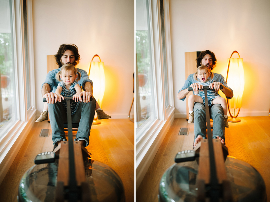 A two year old and her father play on a mid-century style rowing machine during a documentary family portrait session in Ferndale photographed by Ann Arbor Wedding Photographer, Heather Jowett.