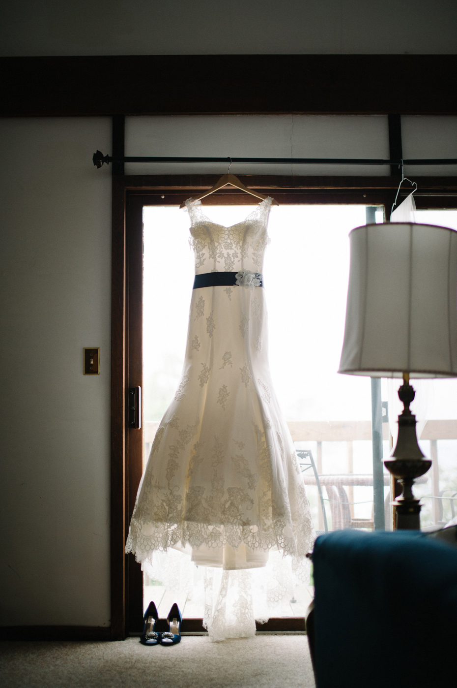 A wedding dress waits for the bride before her wedding at The Inn at Stonecliffe on Mackinac Island by Michigan Wedding Photographer Heather Jowett.