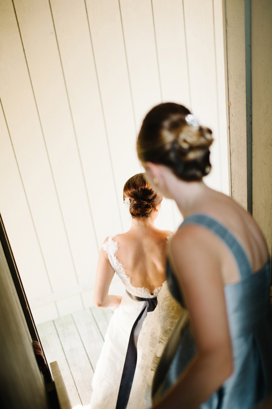 A bride walks through the grounds before her wedding at The Inn at Stonecliffe on Mackinac Island by Michigan Wedding Photographer Heather Jowett.
