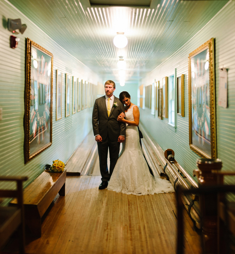 A brenizer method portrait of a bride and groom in the bowling alley at the Woods before their wedding at The Inn at Stonecliffe on Mackinac Island by Michigan Wedding Photographer Heather Jowett.