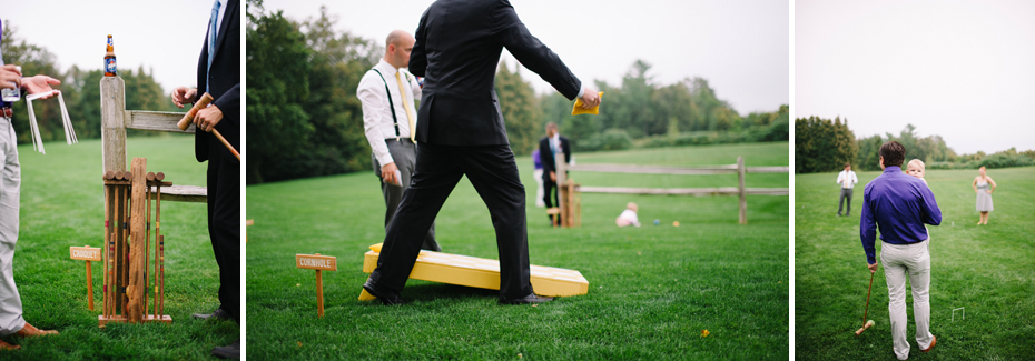 Wedding guests play lawn games including corn hole during an outdoor wedding reception at The Inn at Stonecliffe on Mackinac Island by Ann Arbor Wedding Photographer Heather Jowett.