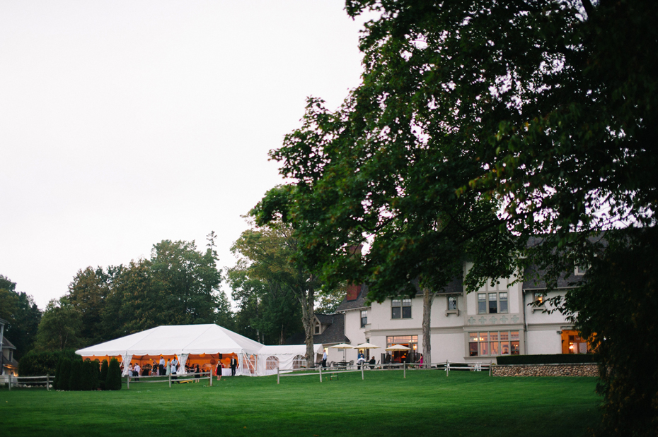 A view of the reception tent and the back of the Inn during an outdoor wedding reception at The Inn at Stonecliffe on Mackinac Island by Ann Arbor Wedding Photographer Heather Jowett.