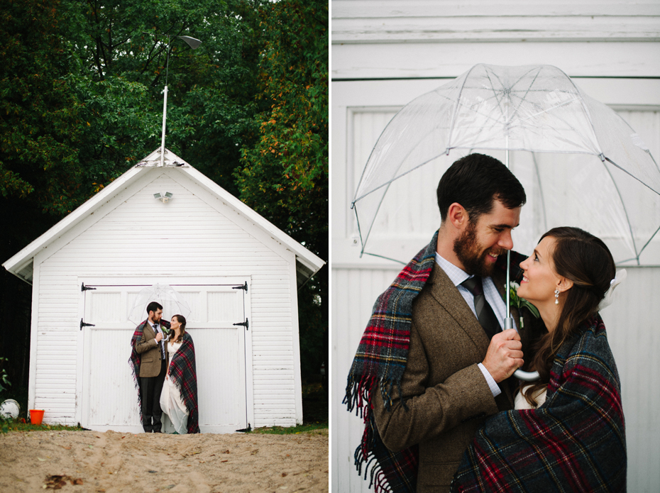 Bride and groom pose for portraits in the rain after their elopement by Ann Arbor Michigan Wedding Photographer Heather Jowett.